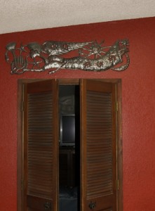 Horizontal pieces, such as this one-of-a-kind angel by LaGuerre Dieufaite, can add interest above an interior doorway.